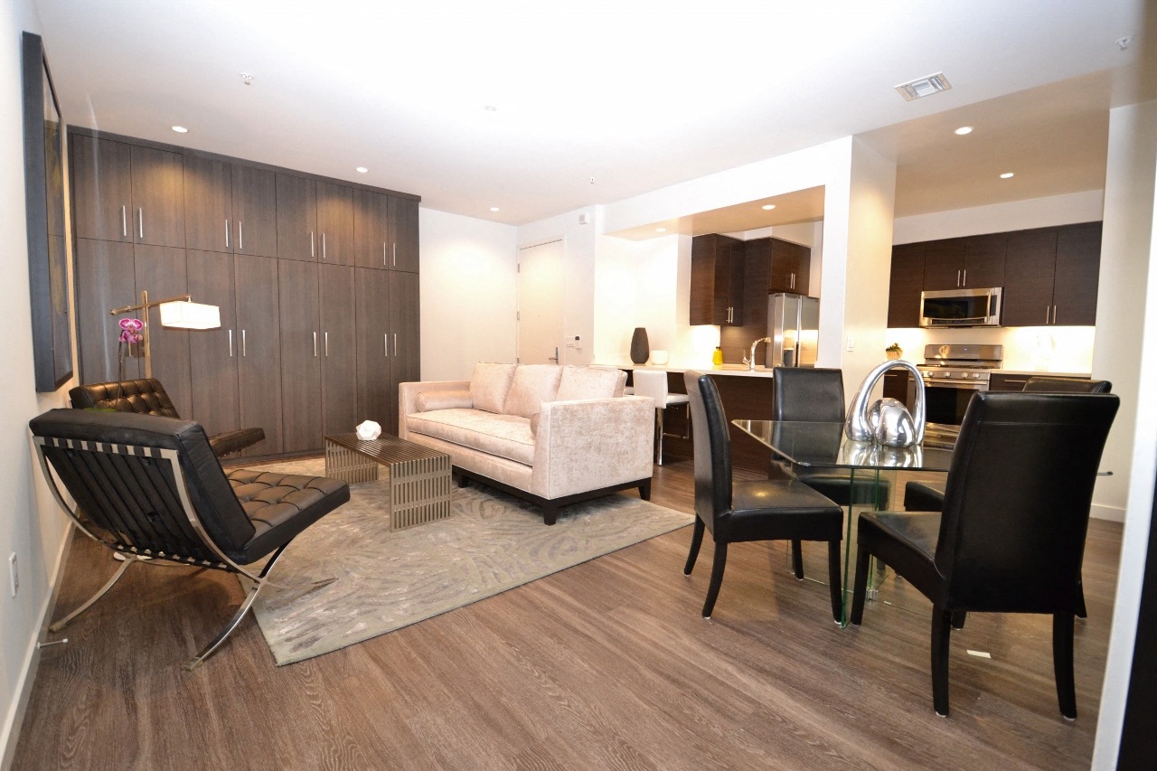 a view of the living room and dining area in a one bedroom suite at the loews